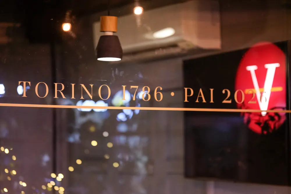 “Torino 1786 · Pai 2026” lettered on the glass, the red V behind · Vermut Café, Pai Walking Street