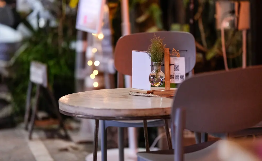 A terrace table set with a sprig of rosemary, early in the evening · Vermut Café, Pai Walking Street