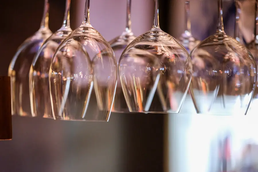 Wine glasses hanging above the counter · Vermut Café, Pai Walking Street