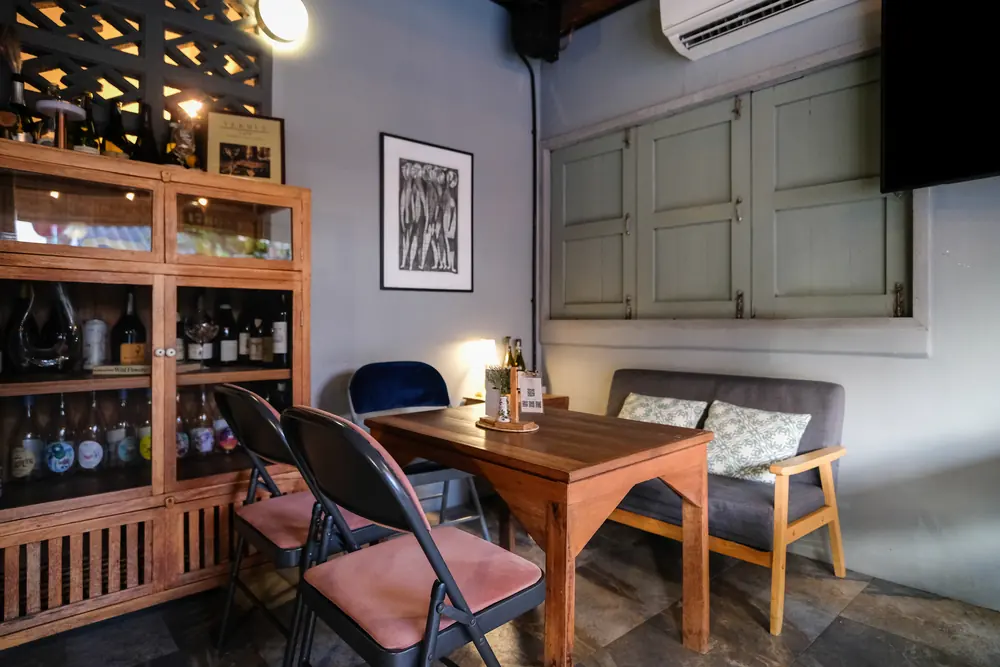 A table and chairs beside the wine cabinet, ground floor · Vermut Café, רחוב ההליכה בפאי