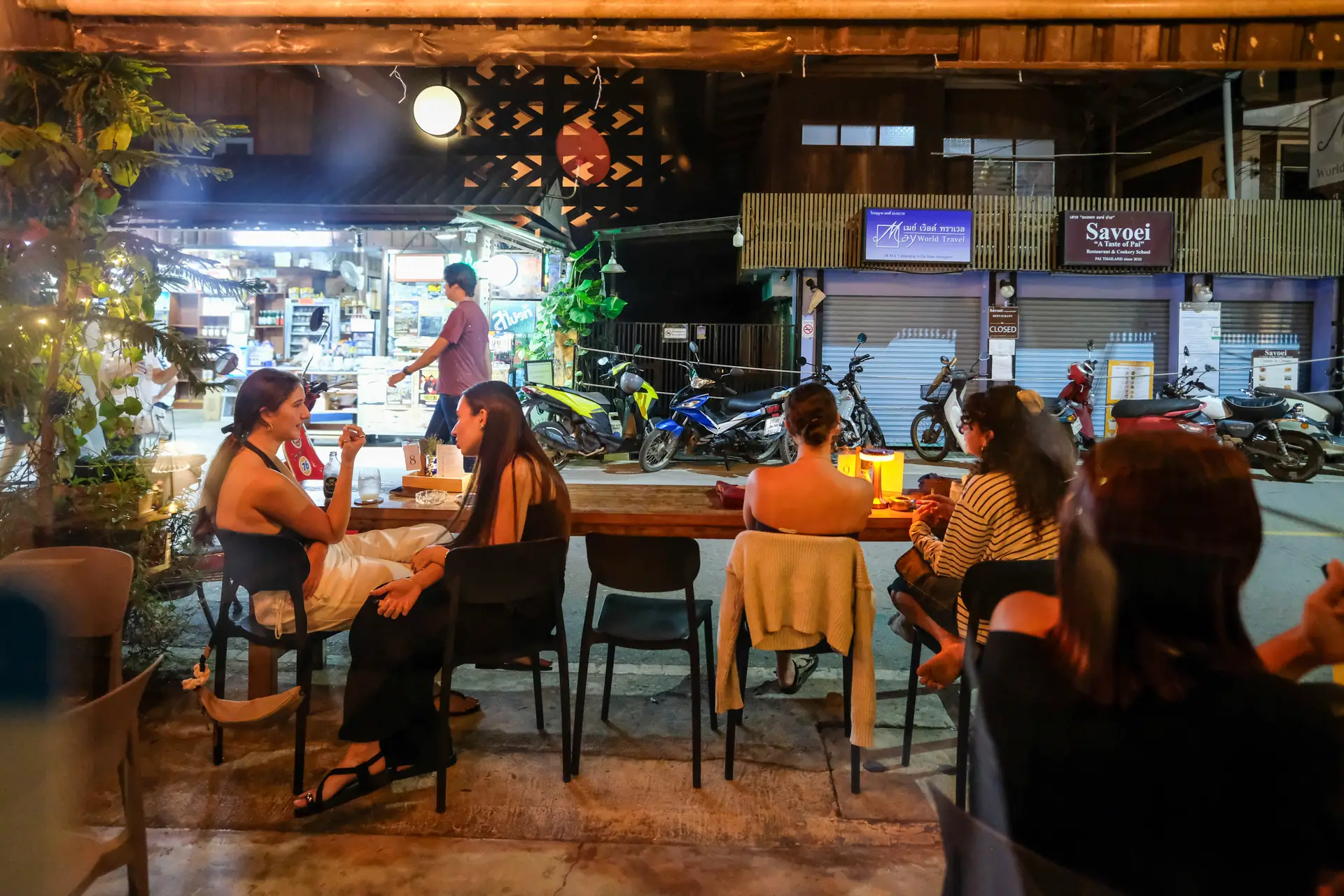 Tables out front at Vermut Café facing Pai Walking Street in the evening